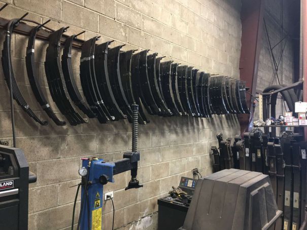 A row of fender flares hanging on a wall in a garage.