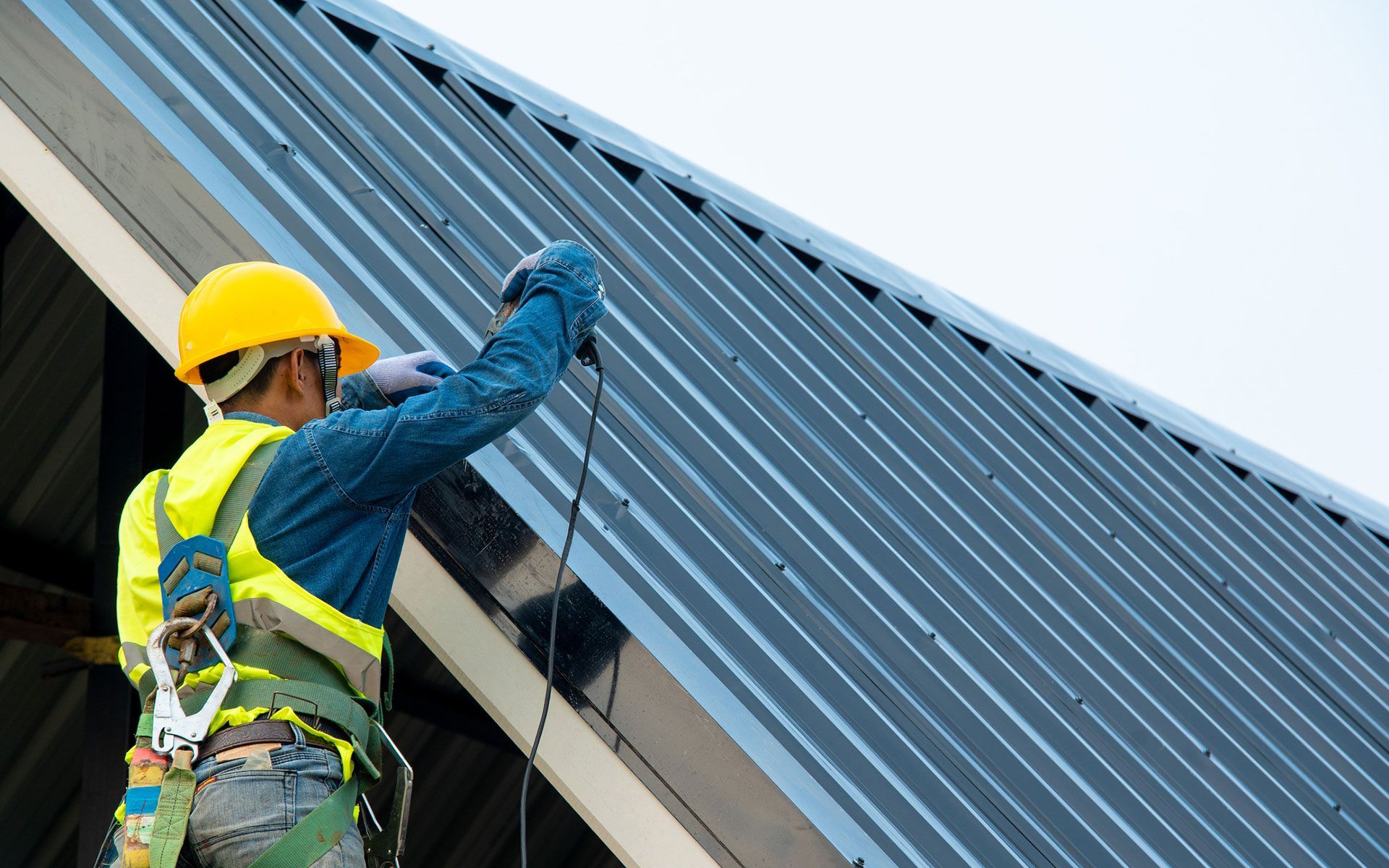 A man is working on the roof of a building.