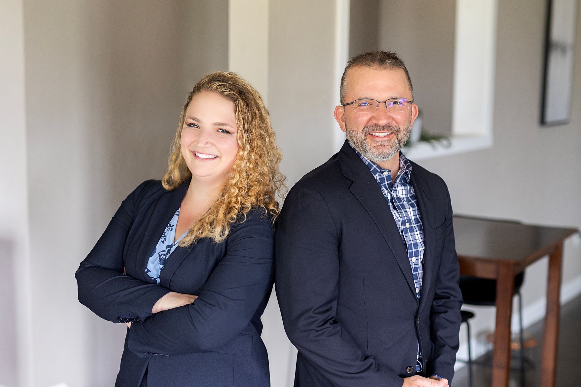 A man and a woman are standing next to each other in a room.