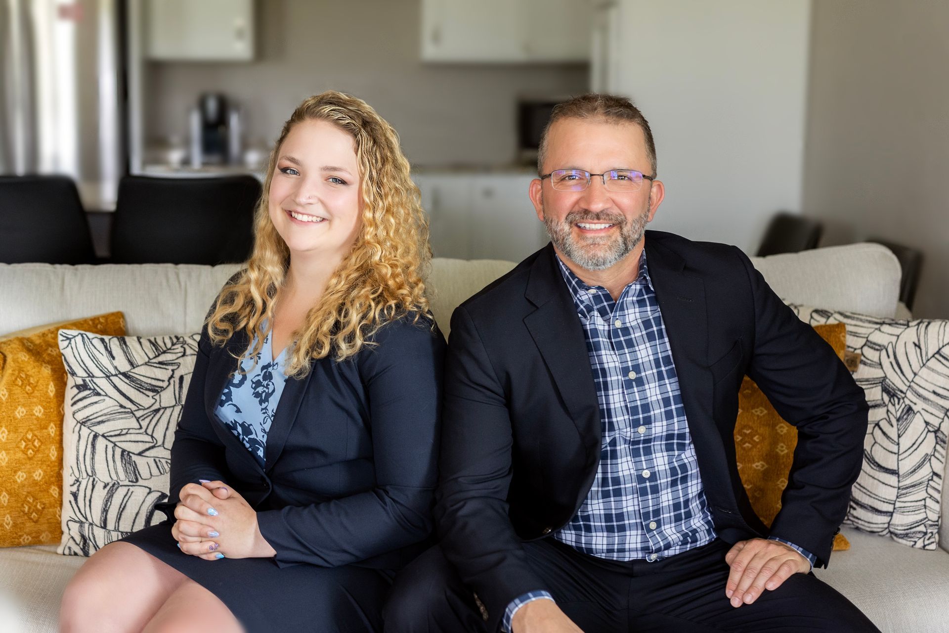 A man and a woman are sitting next to each other on a couch.