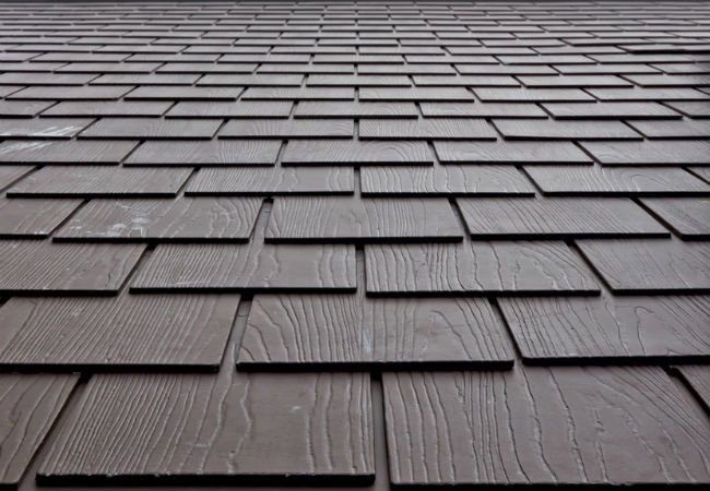 A close up of a roof made of wooden tiles.
