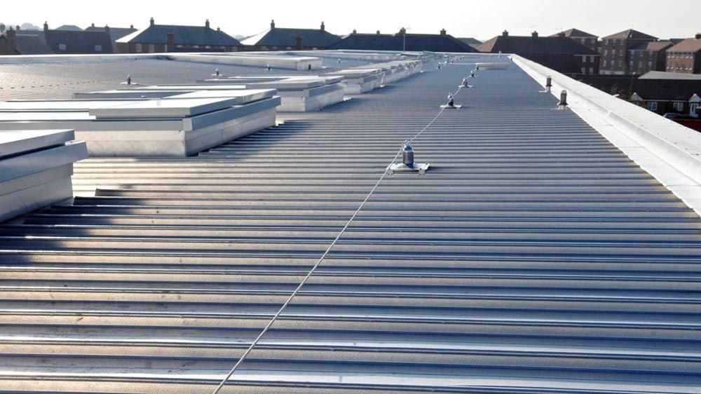 The roof of a building with a safety line on it.