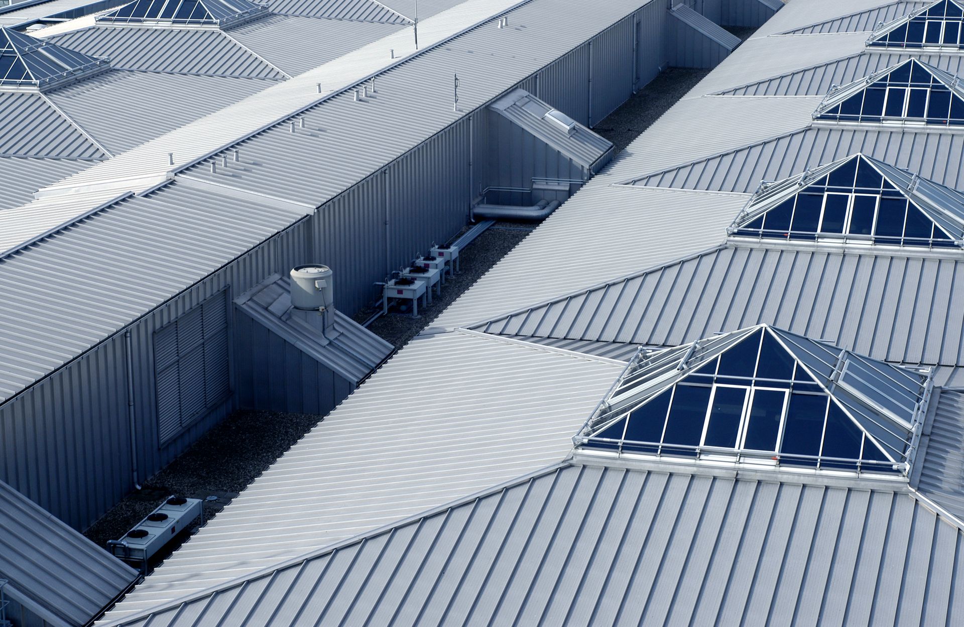 The roof of a building has a lot of skylights on it