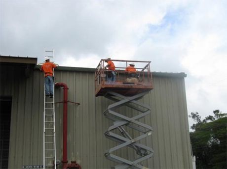 Professional staff of A-Plus Seamless Raingutters INC installing commercial gutters