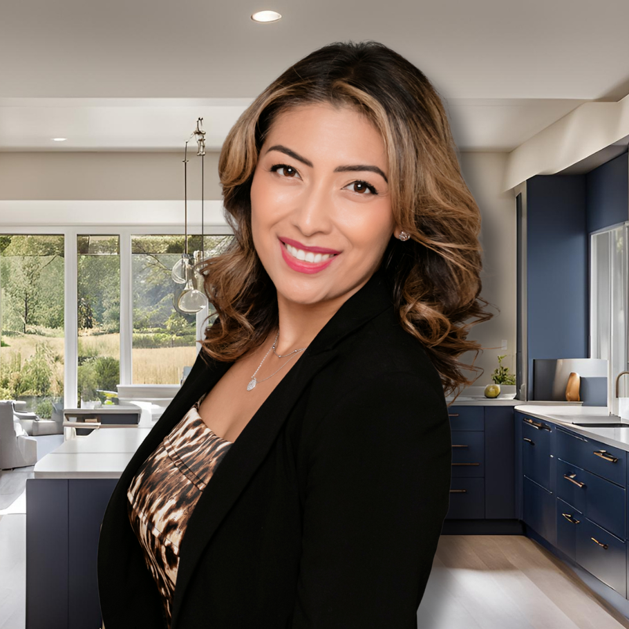 A woman in a black jacket is standing in a kitchen