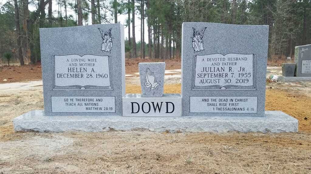 a couple of graves in a cemetery with the name dowd on them .