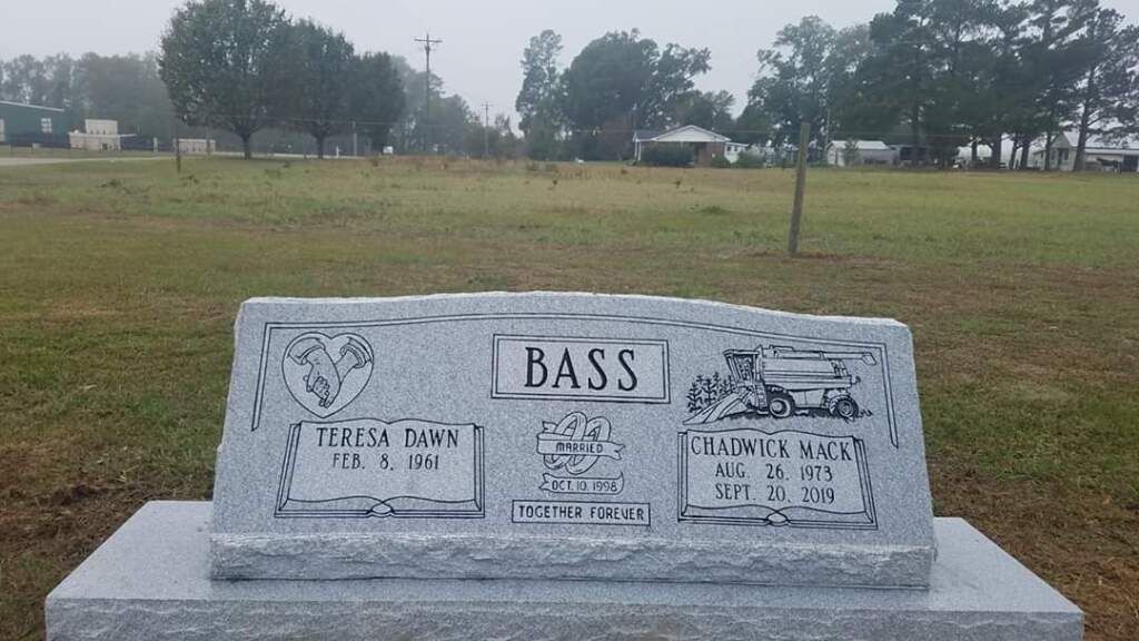 a gravestone with the name bass on it
