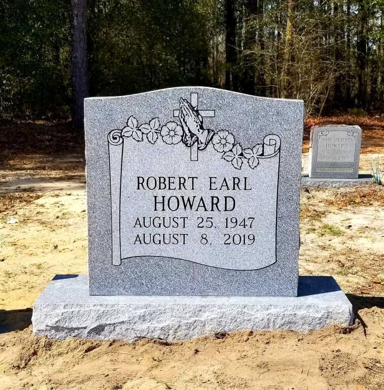a gravestone for robert earl howard is in a graveyard