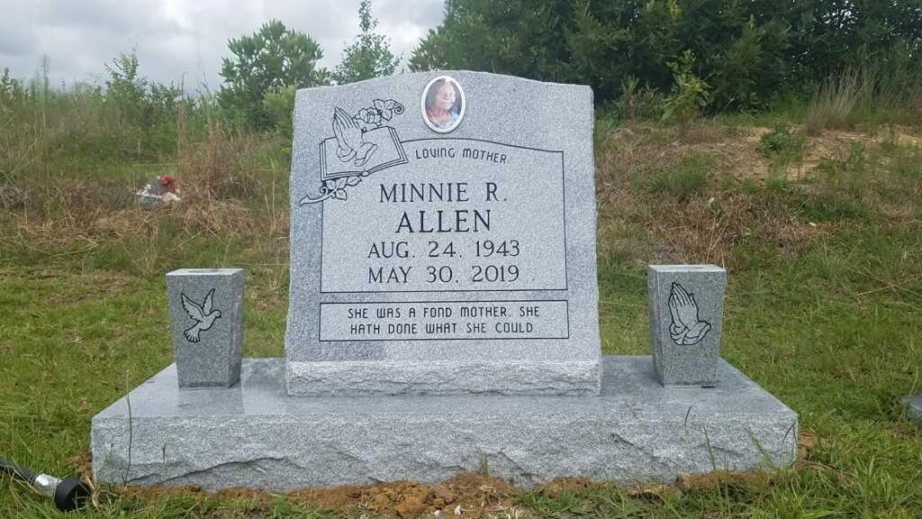 a gravestone in a cemetery with a picture of a woman on it .