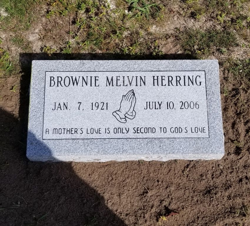 a gravestone for brownie melvin herring in a graveyard