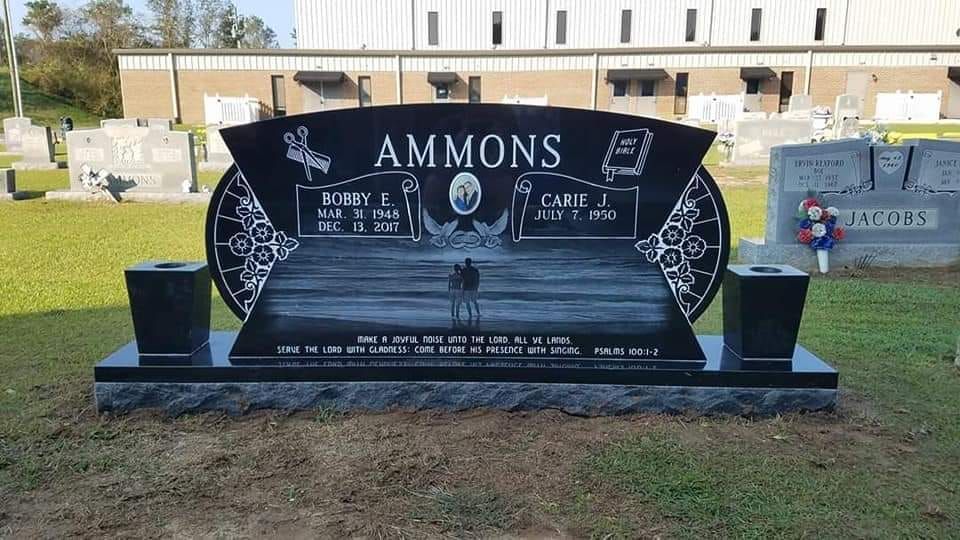 a black gravestone with the name ammons on it