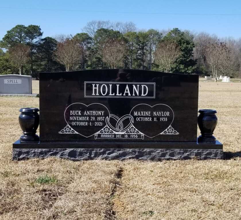 a black gravestone with the name holland on it
