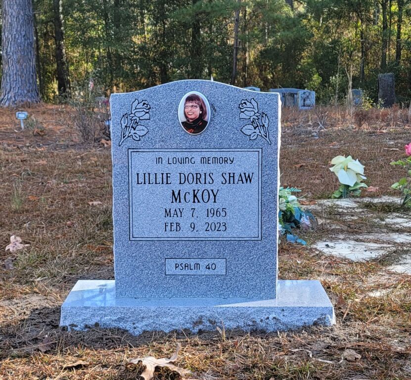 a gravestone for lillie doris shaw mckoy in a cemetery