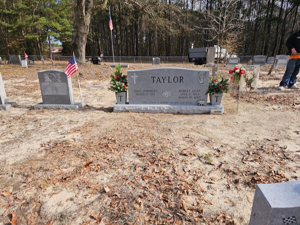 a grave in a cemetery with the name taylor on it