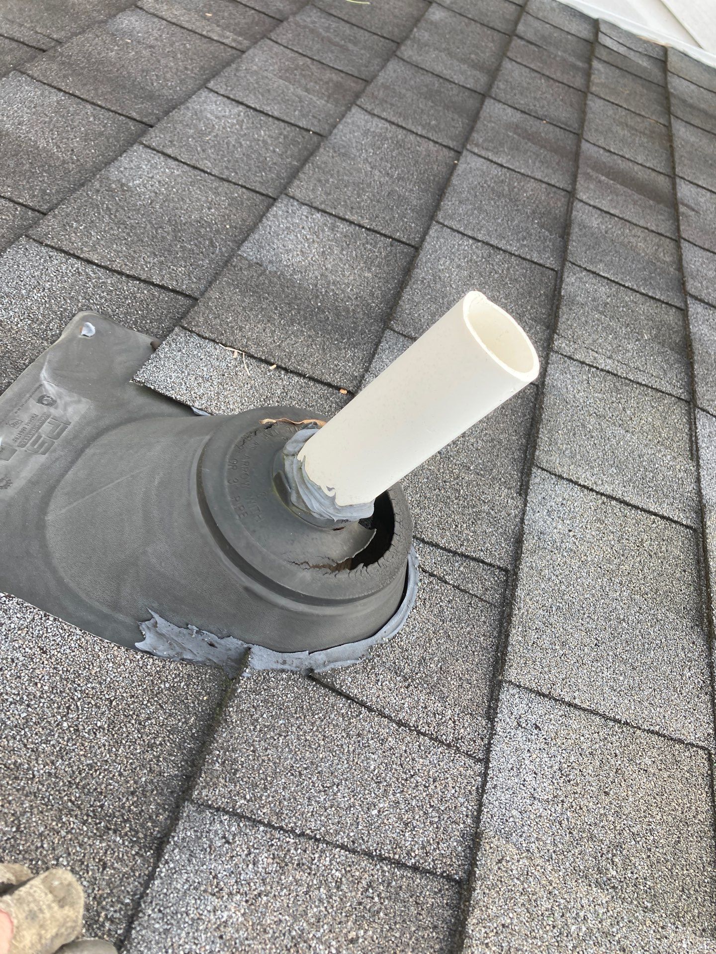 A pipe is sitting on top of a tiled roof.