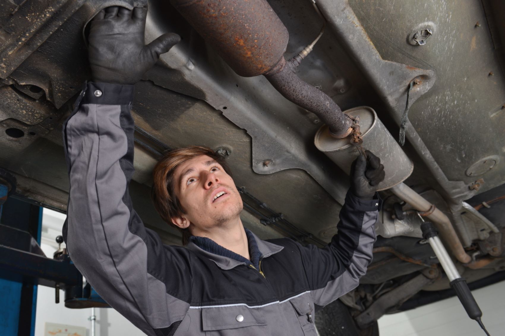 A Man is Working on the Underside of a Car — Alstonville Rego & Mechanical in Alstonville, NSW
