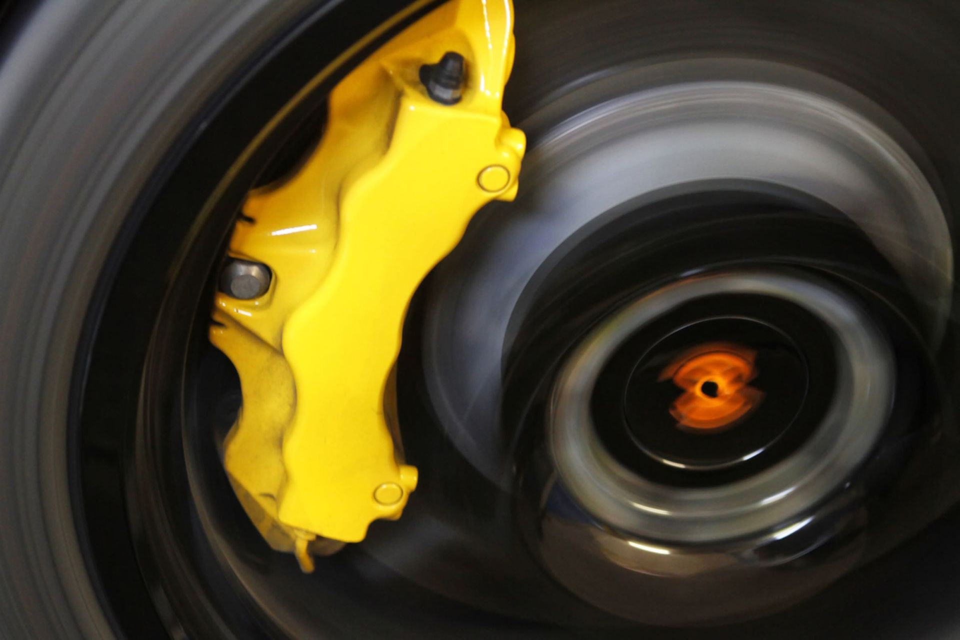 A Close Up of a Yellow Brake Caliper on a Car Wheel — Alstonville Rego & Mechanical in Alstonville, NSW