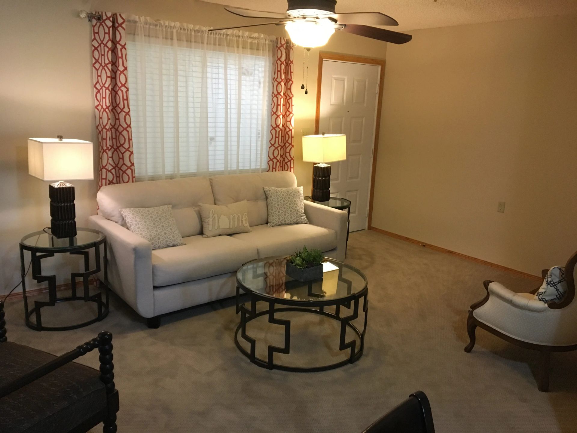 A living room with a couch and two coffee tables for independent living facility