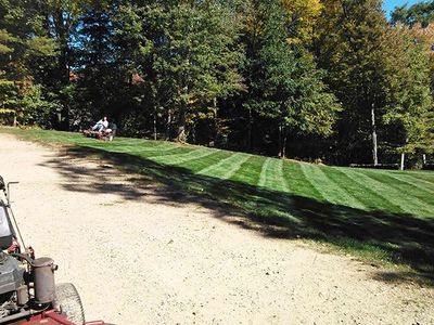 Landscape Company — Man Riding Lawn Mower in Derry, NH