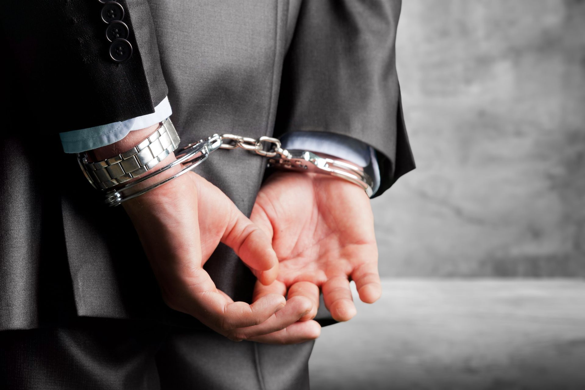 Male hands in handcuffs.