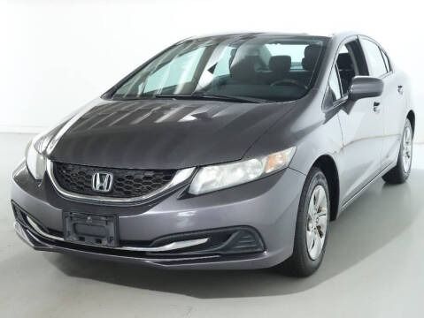 Gray Honda Civic sedan parked in a studio setting.