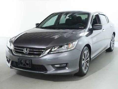 Gray Honda Accord sedan parked in a studio.