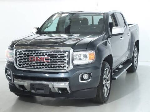 Dark gray GMC Canyon pickup truck angled slightly to the right, in a studio with a white background.
