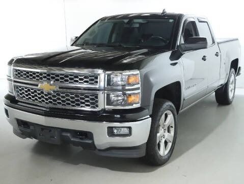 Black and silver Chevrolet Silverado truck in a studio setting.