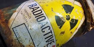 Close-up of a weathered yellow barrel labeled