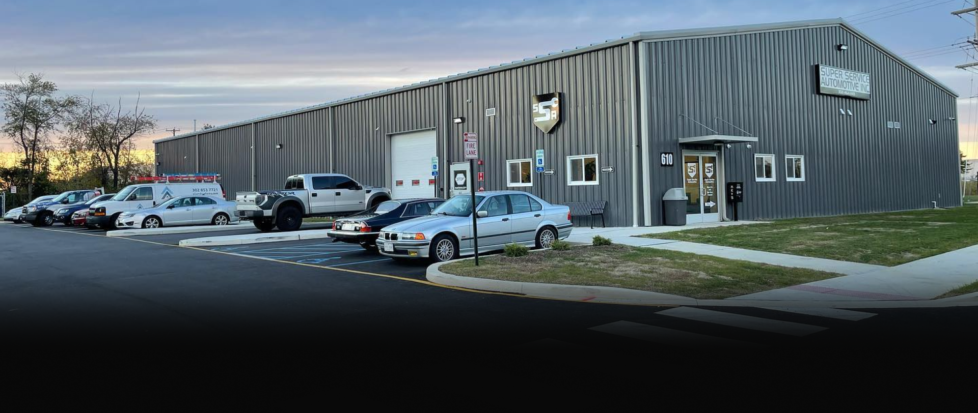 Industrial building with parked cars in front on a snowy day
