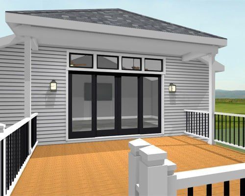 Modern house deck with black railings, double glass doors, and white siding beneath a gray roof.