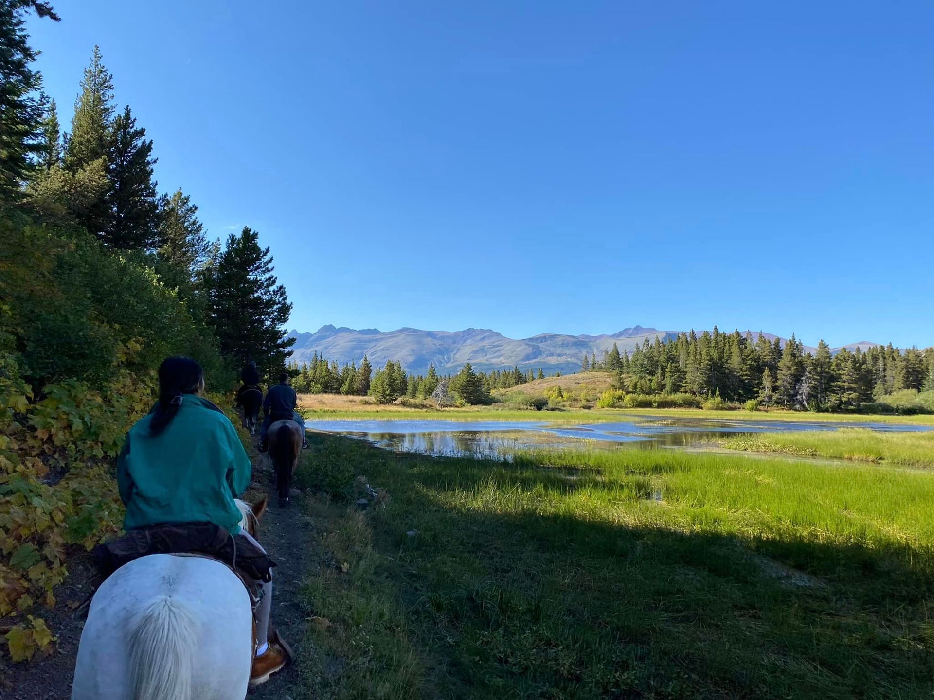 Group of People Riding Horses in a Beautiful Scenery