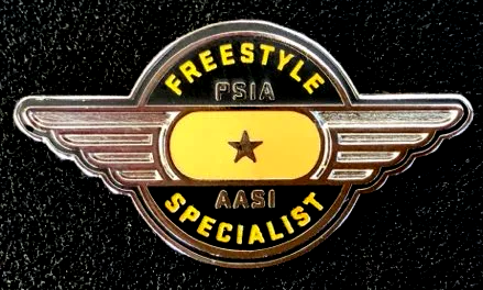 A pin that says freestyle psia specialist on it