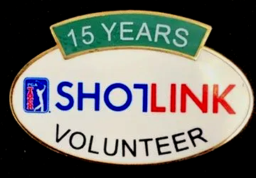 A pin that says 15 years shotlink volunteer