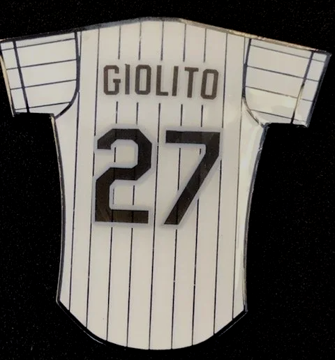 A white jersey with the number 27 on it
