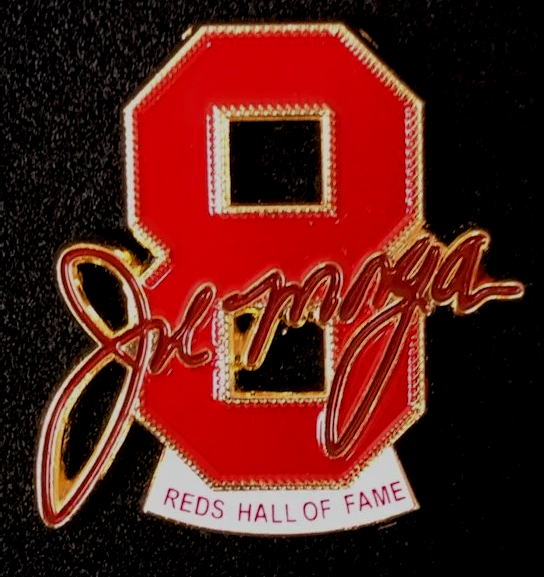 A red pin that says ' reds hall of fame ' on it