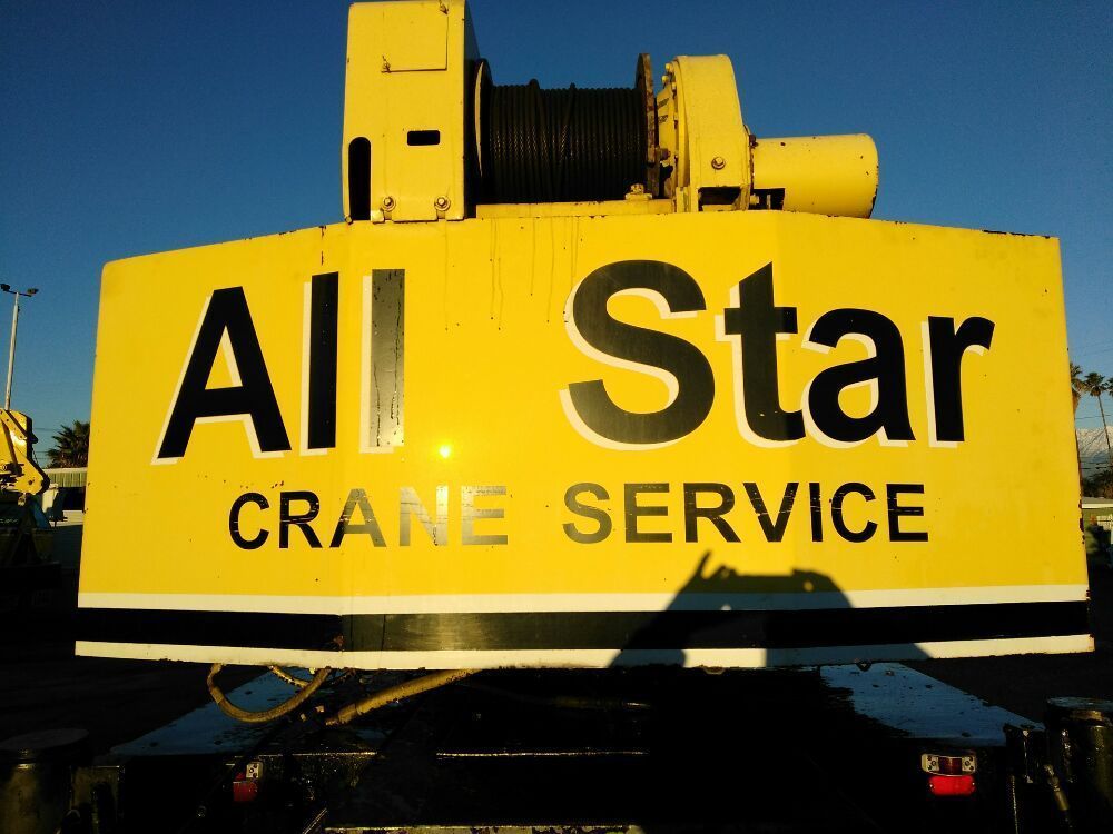 A yellow sign that says all star crane service