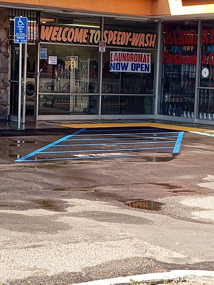 A handicapped parking spot in front of a laundromat