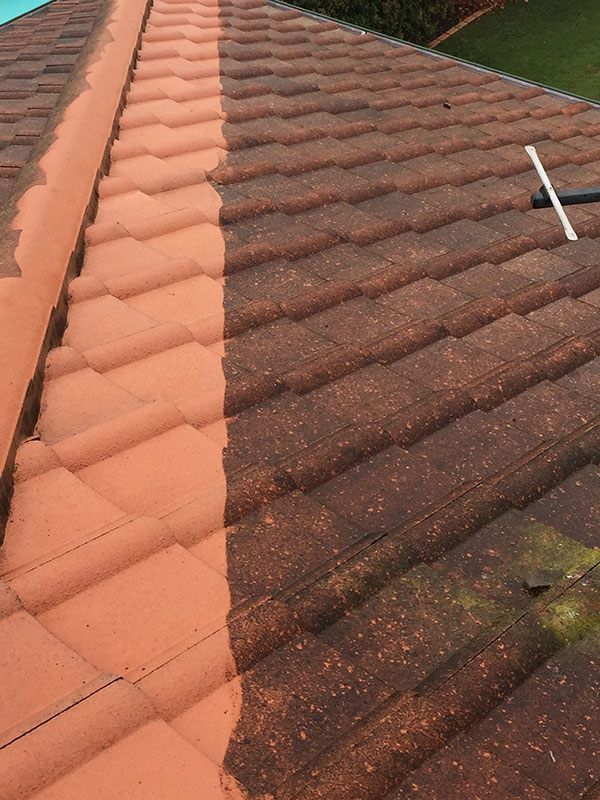 A before and after picture of a tile roof being cleaned.