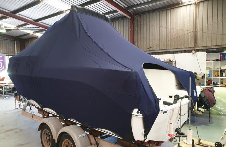 Dark blue boat cover for winter storage or protection.