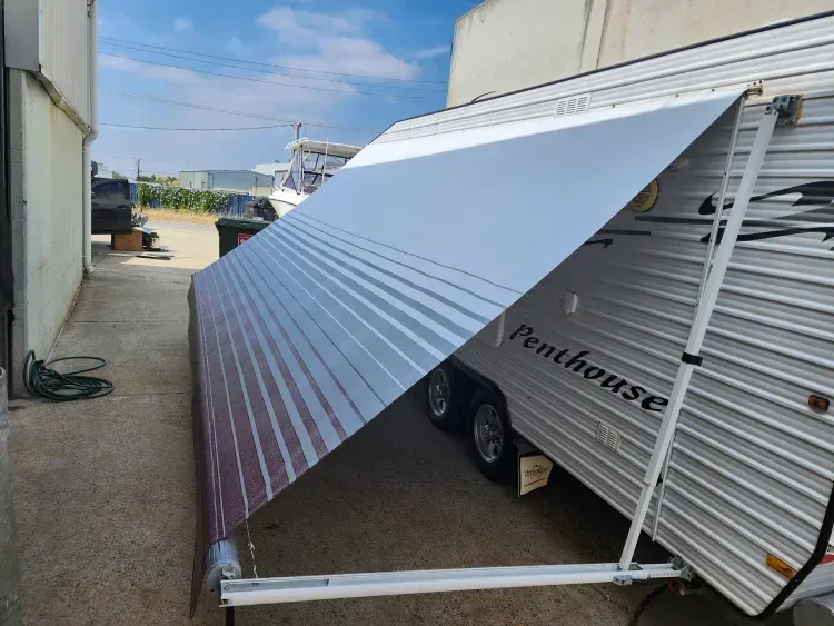 modern grey and red striped caravan awning fully extended