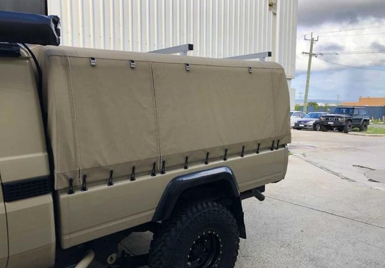 Custom tan canvas UTE canopy on a utility vehicle with a tray.