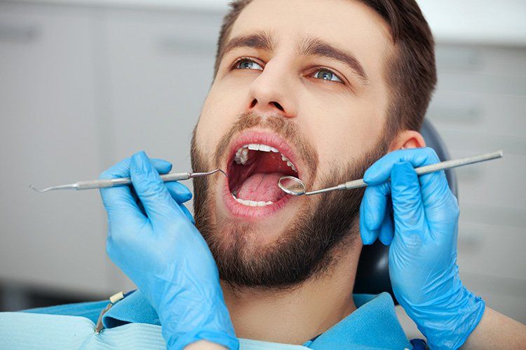 man at the dentist, dental examination