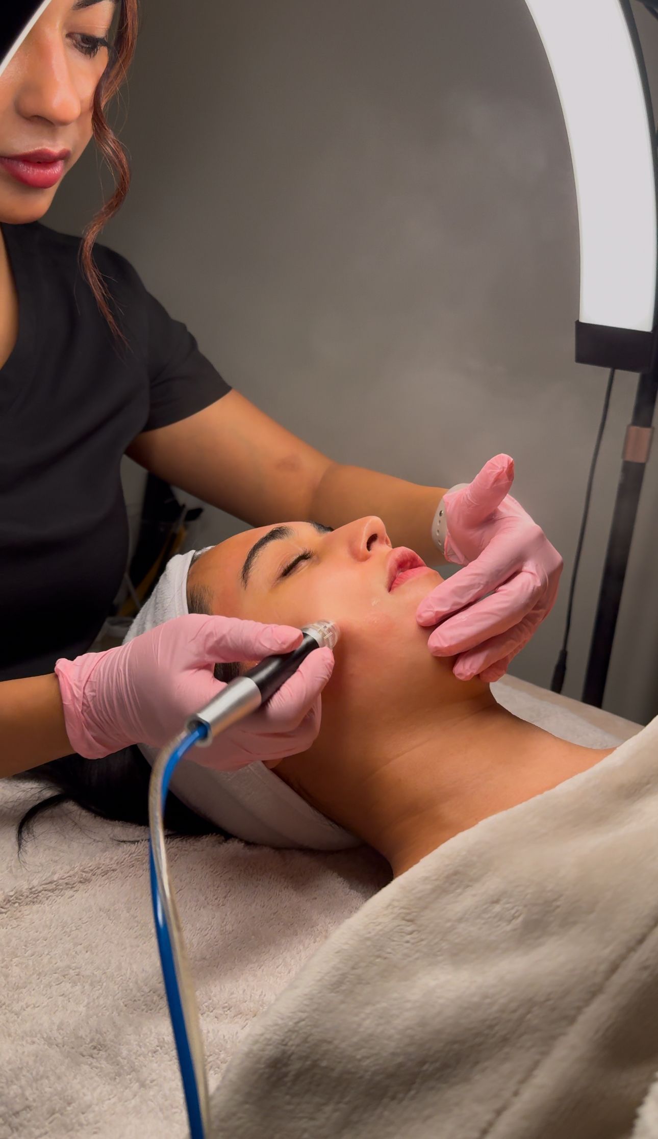 A woman is getting a facial treatment at a beauty salon.