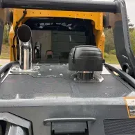 Off-road vehicle dashboard with black snorkel, roof rack, and windshield visible through yellow roll cage