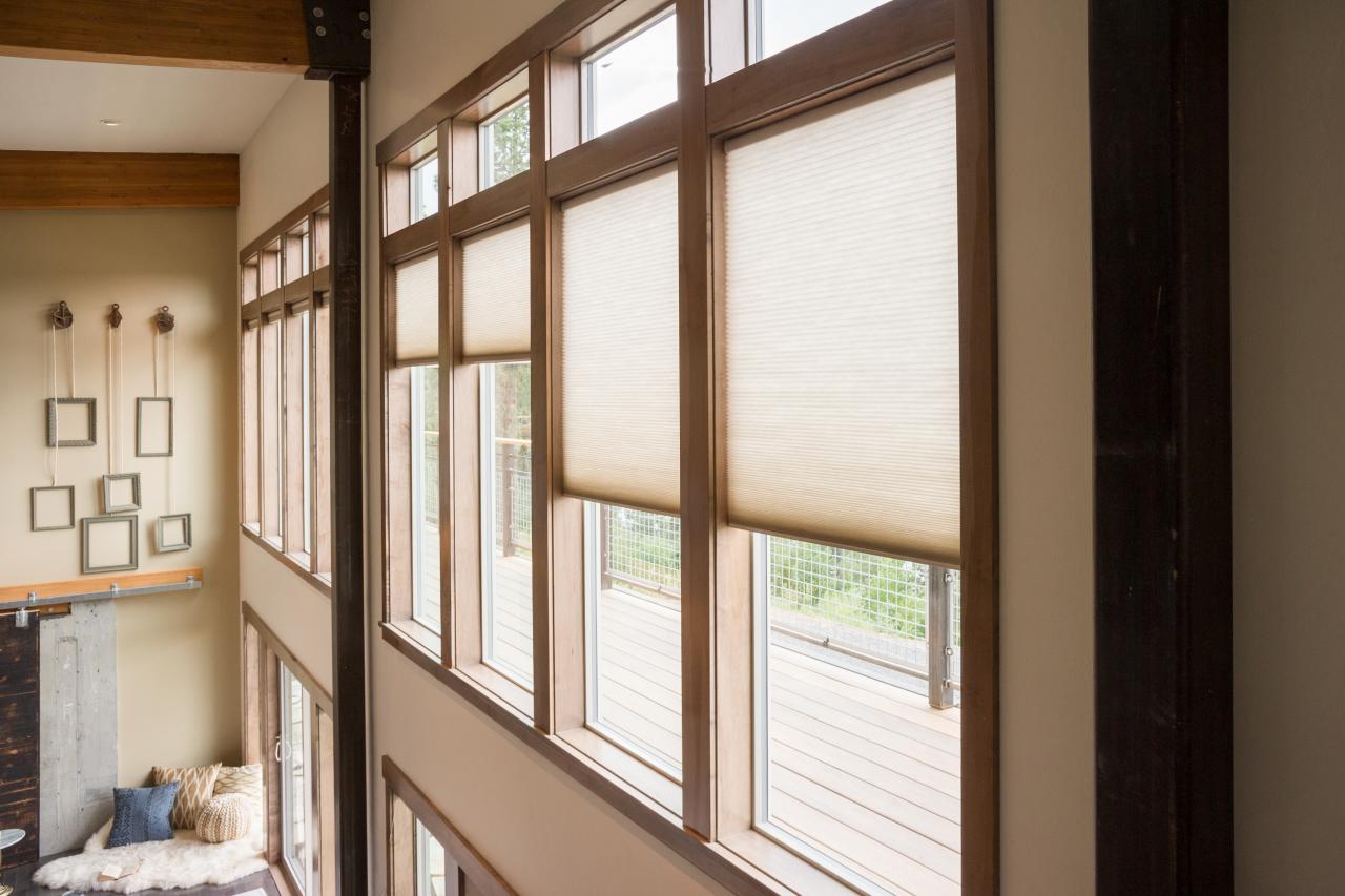 Second story peach roller shades with balcony and living room view