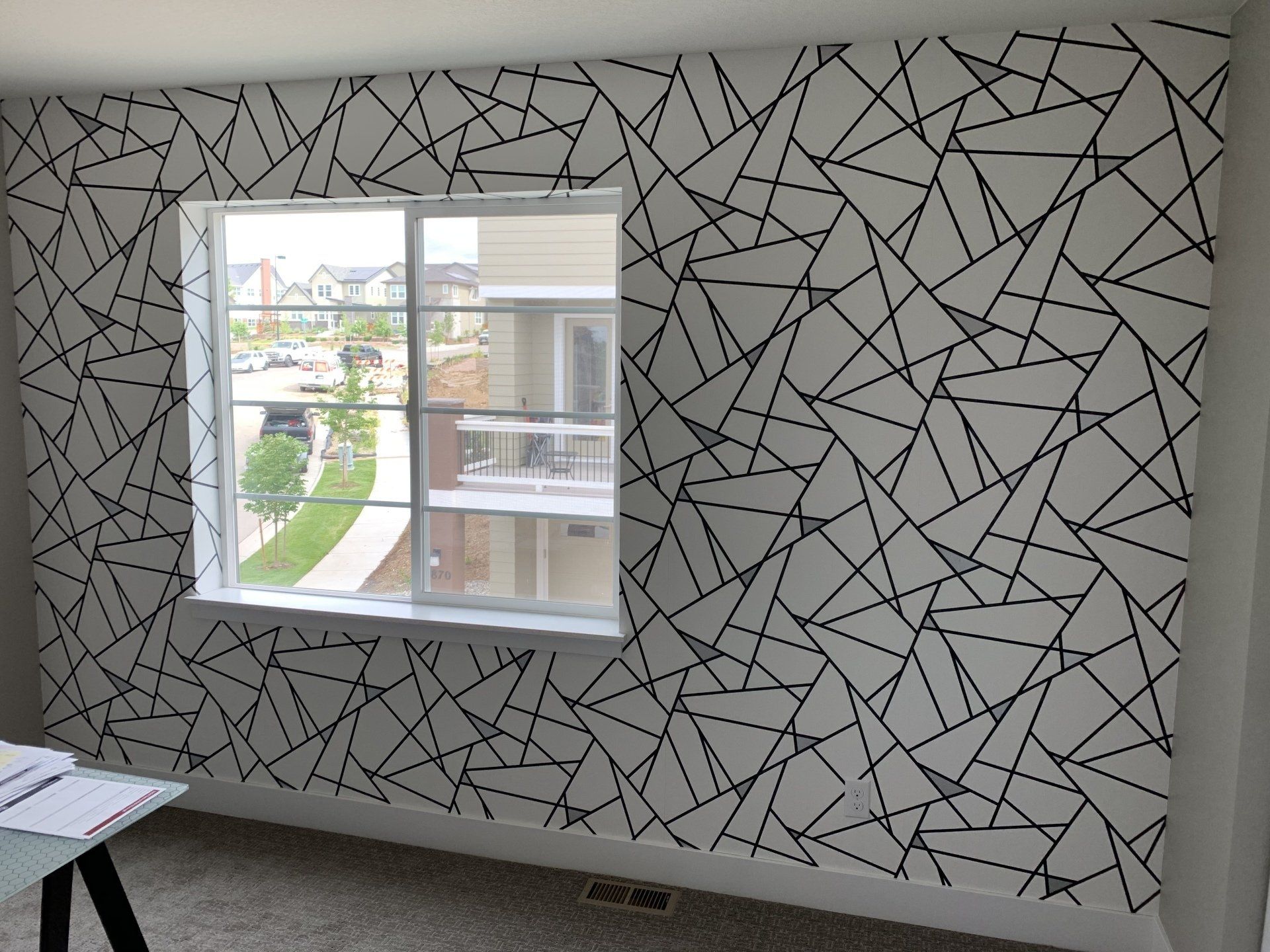 Geometric triangle patterned white, gray, and black wallpaper