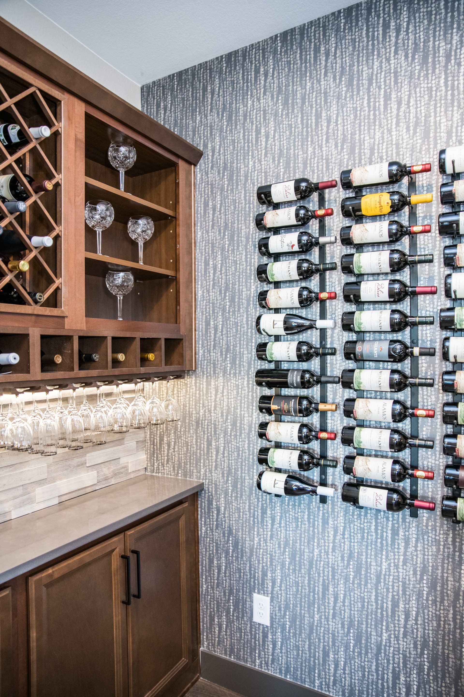 Gray, pink and white dotted pattern wallpaper under a wine rack