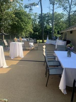 A patio with tables and chairs set up for a party.