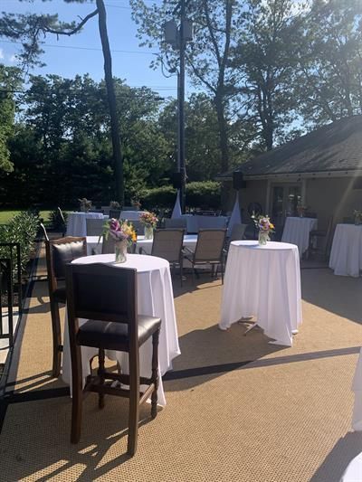 A patio with tables and chairs set up for a party